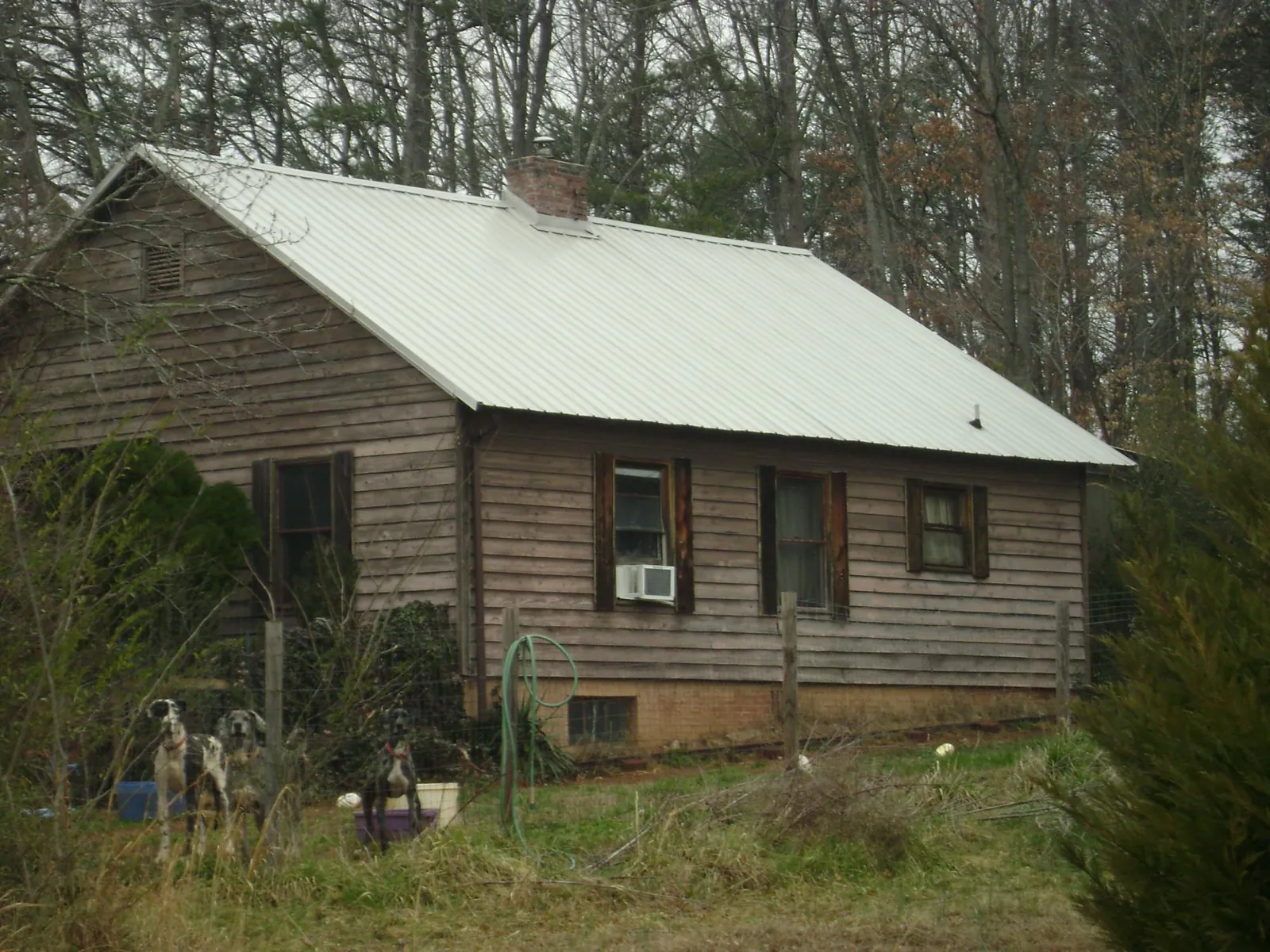 White metal roof on an old wood sided farmhouse, from a Metal Roof Installation job in Connelly
